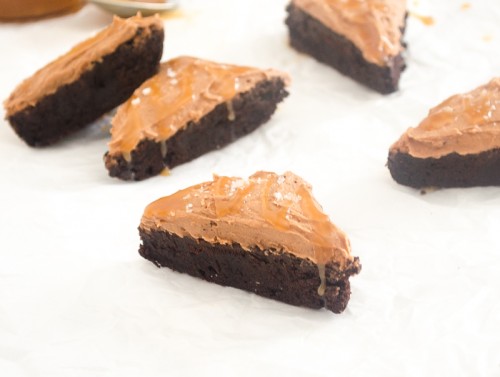 Cocoa Brownies with Salted Caramel frosting on parchment