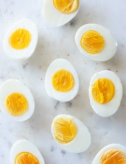 hard boiled eggs cut in half on a marble board