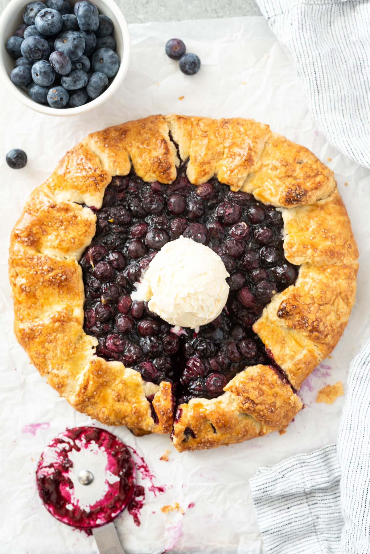 Blueberry galette with scoop of ice cream in center
