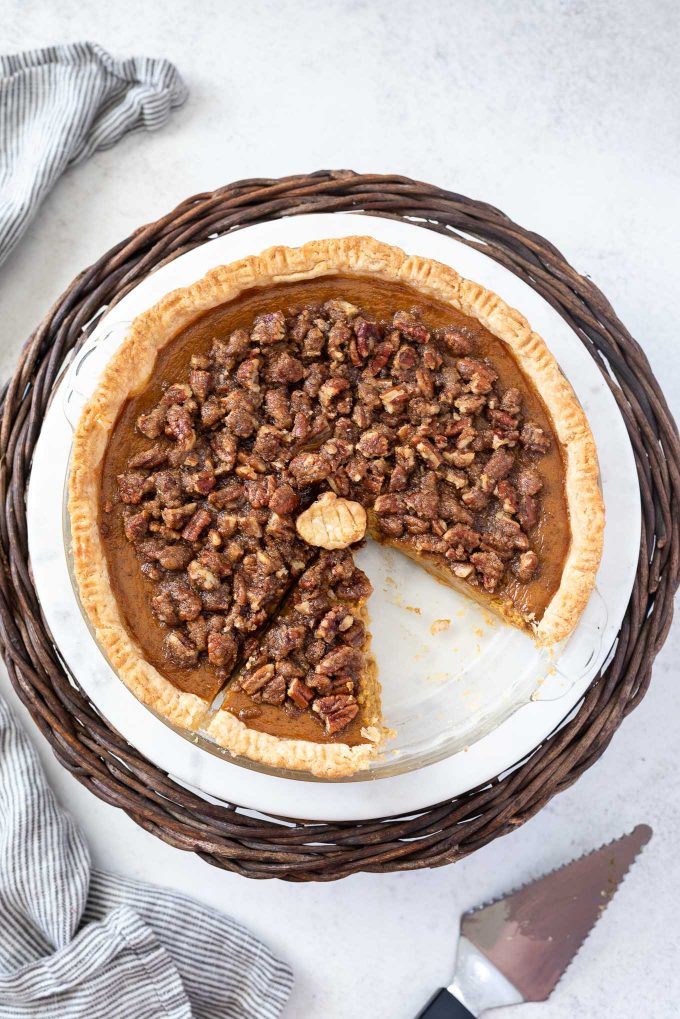 Pumpkin pie with pecan topping with slice missing