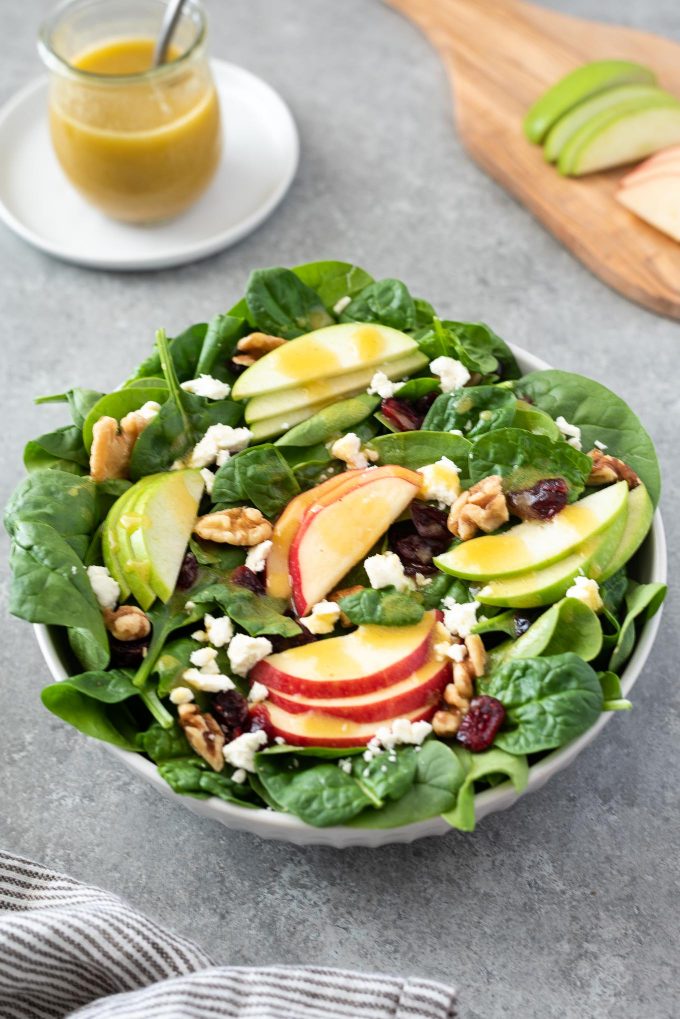 Close up of Spinach Apple Salad in white bowl