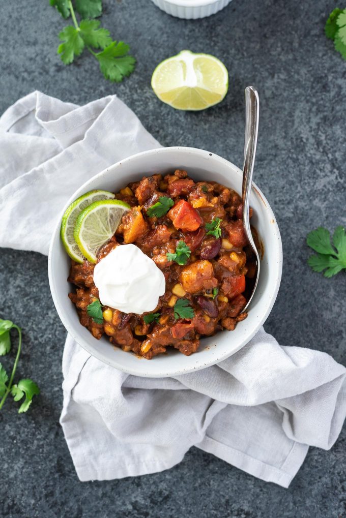 Bowl of instant pot butternut squash chili on top of a linen