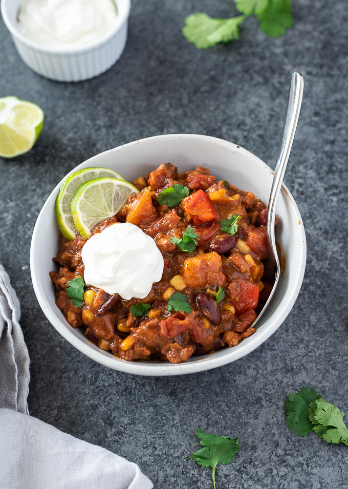 Butternut squash chili with sour cream and lime on top