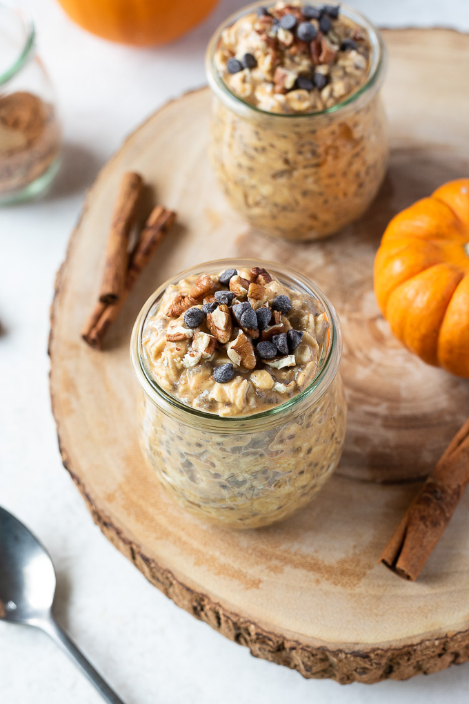 Pumpkin pie overnight oats in a jar with chocolate chips and pecans on top