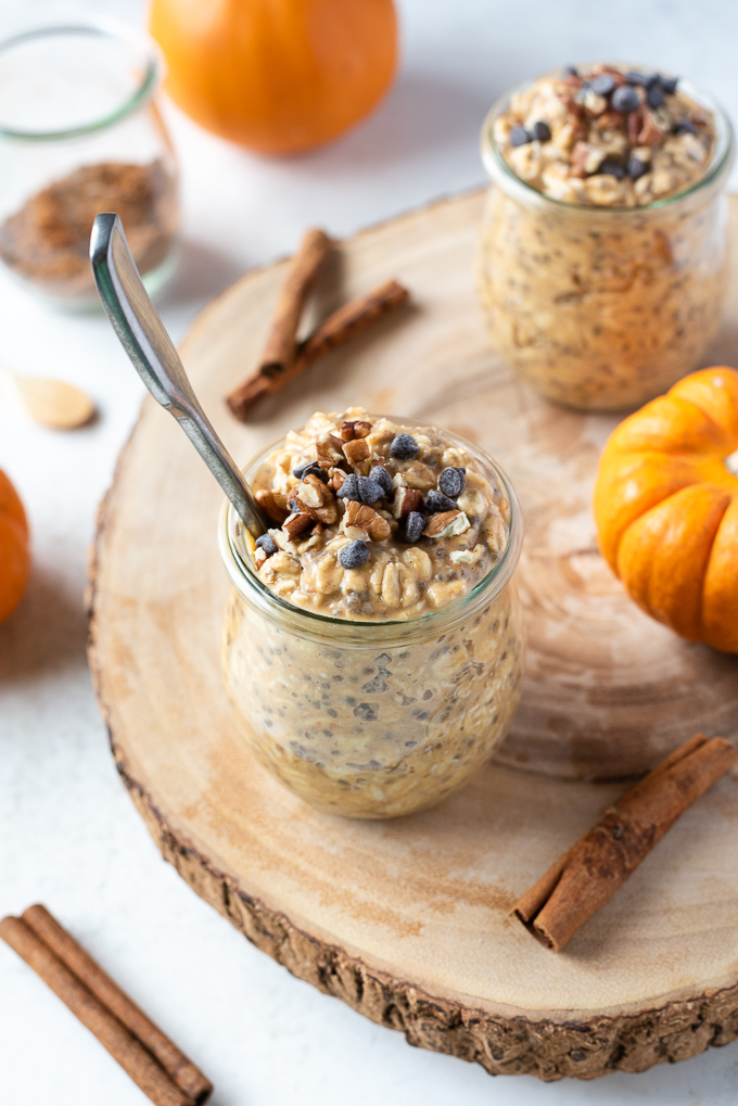 Pumpkin overnight oats in a jar with spoon buried in the middle