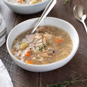 Crockpot turkey wild rice soup in a bowl with spoon