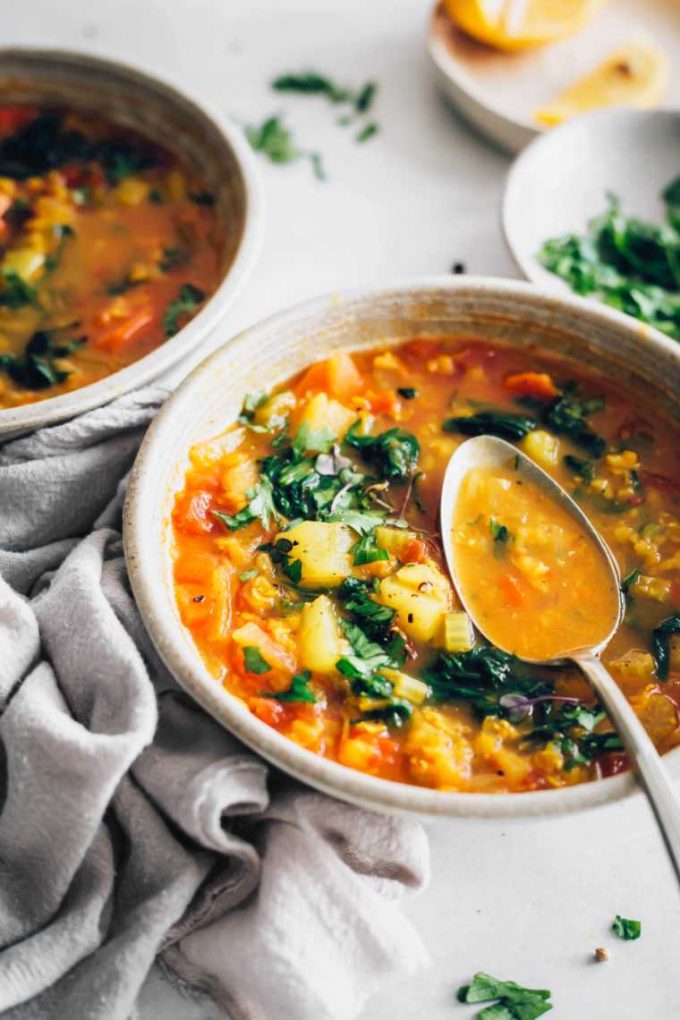 Vegan red lentil soup in a bowl with a spoon