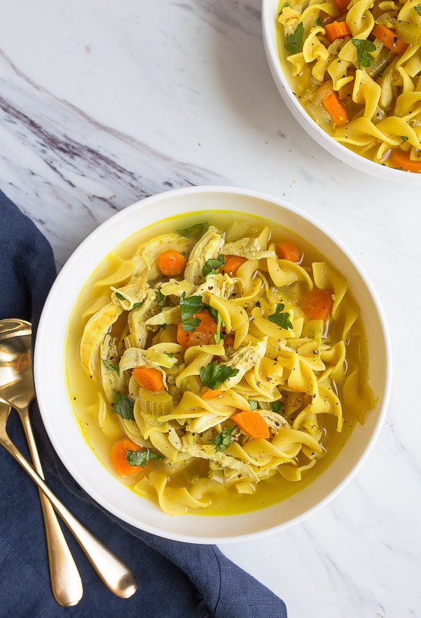 Bowl of instant pot chicken noodle soup with spoons