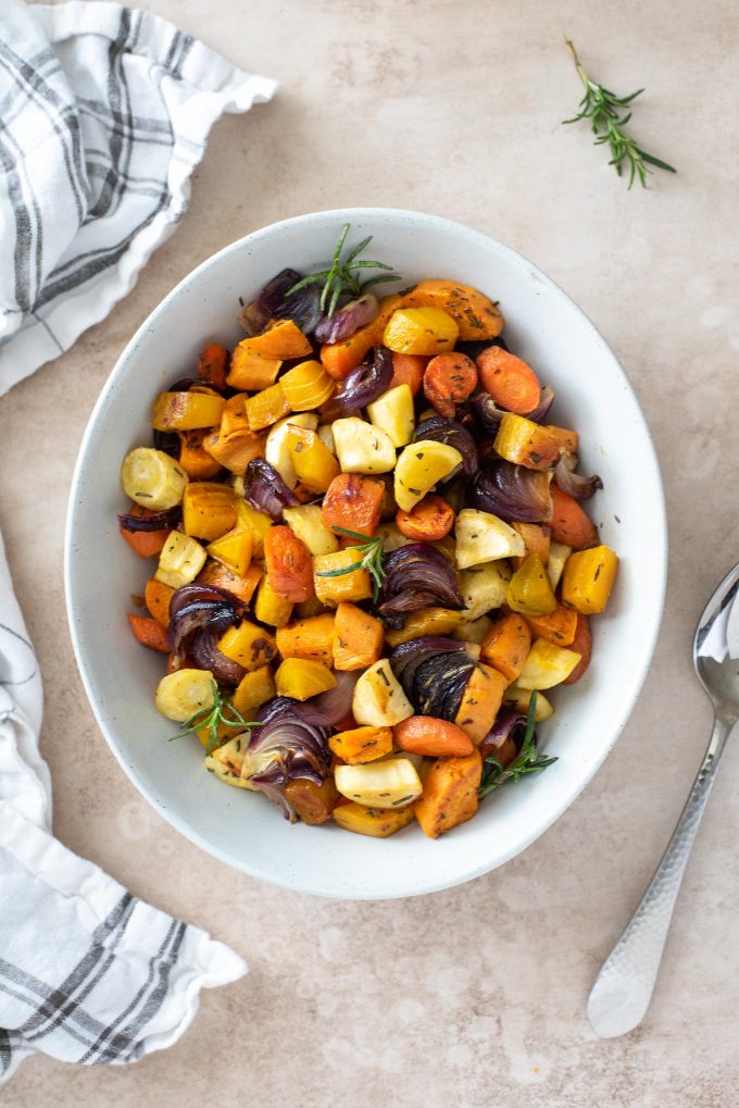 Roasted root vegetables in a white serving bowl