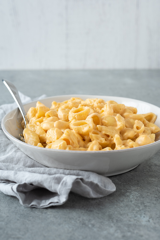 One pot mac and cheese in a white bowl with linen