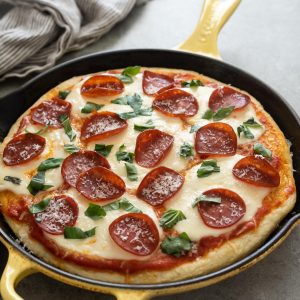 Focaccia pizza with pepperoni and torn basil