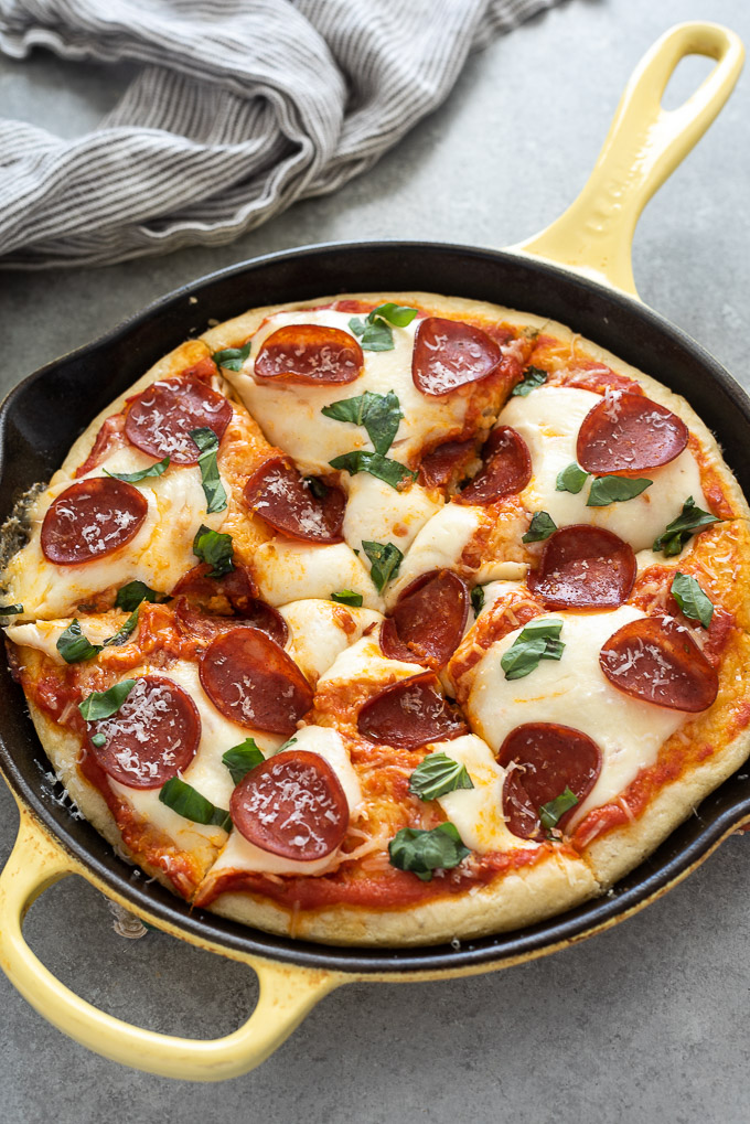 Cast iron skillet with sliced focaccia pizza
