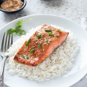 Miso salmon over rice on a plate