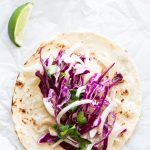 Overhead view of a spicy fish taco with fennel slaw.