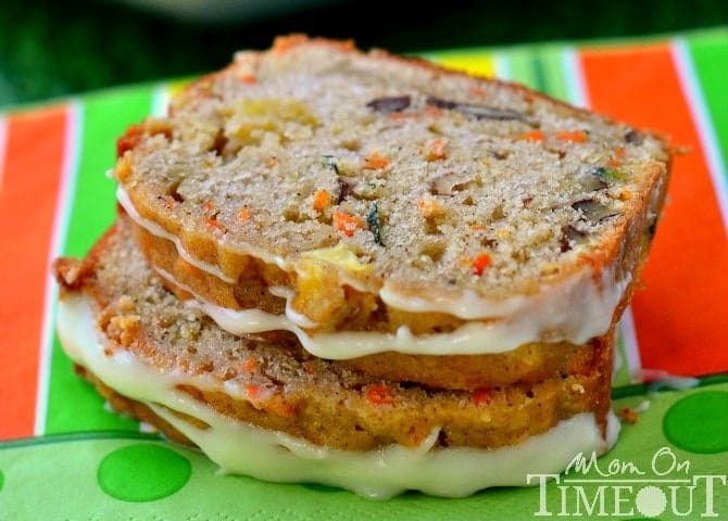 Two slices of glazed carrot apple zucchini bread stacked on each other.