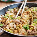 Cabbage stir fry in a skillet with chopsticks.