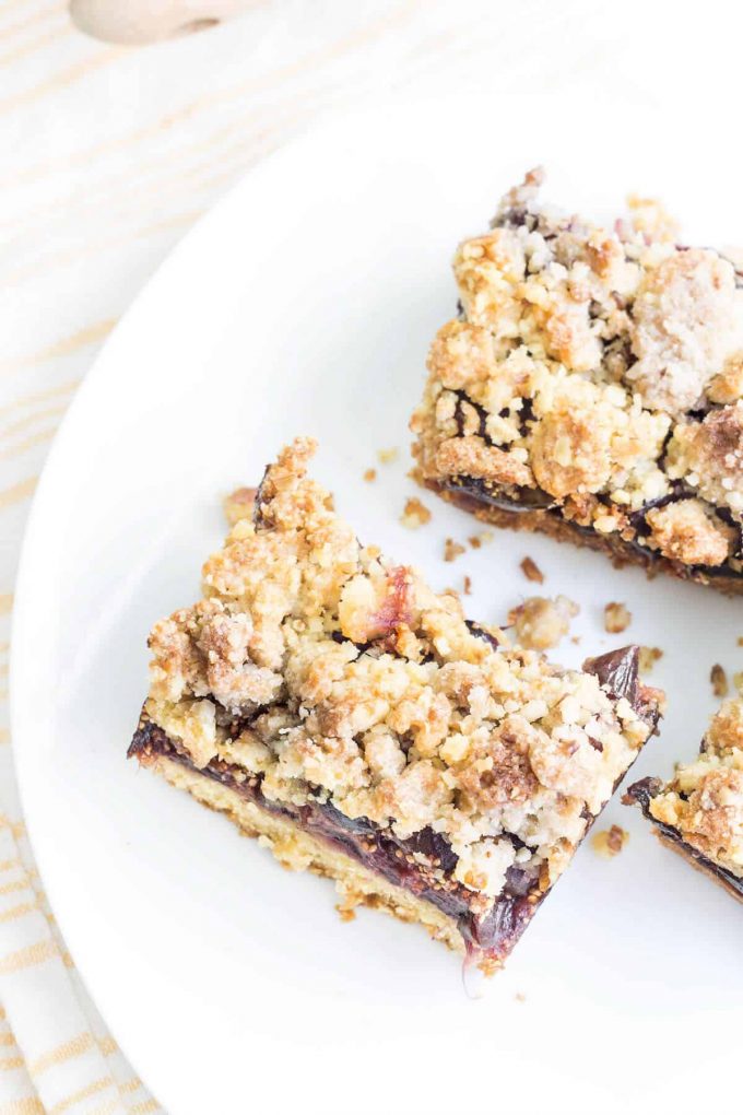 Two fig crumble bars on a white plate.