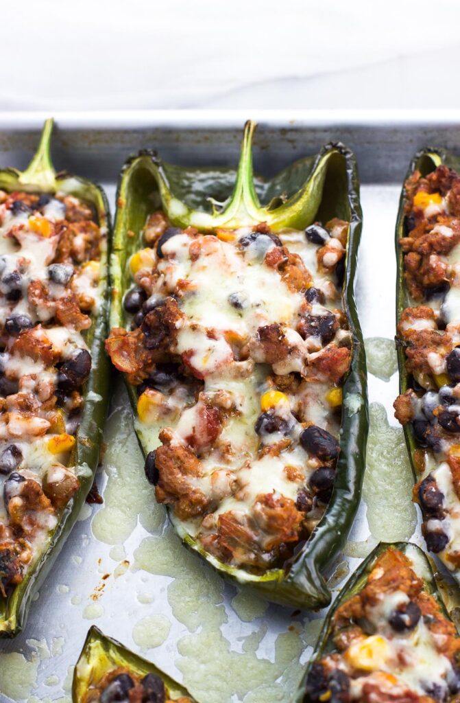 Healthy stuffed poblano peppers on a baking tray.