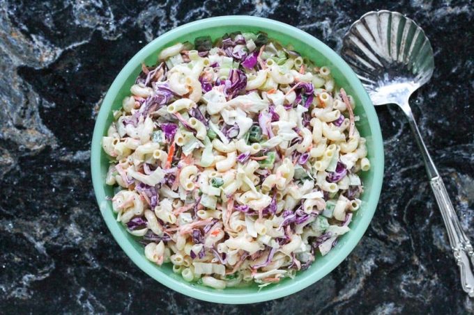 Overhead view of a blue bowl of gluten free macaroni slaw.