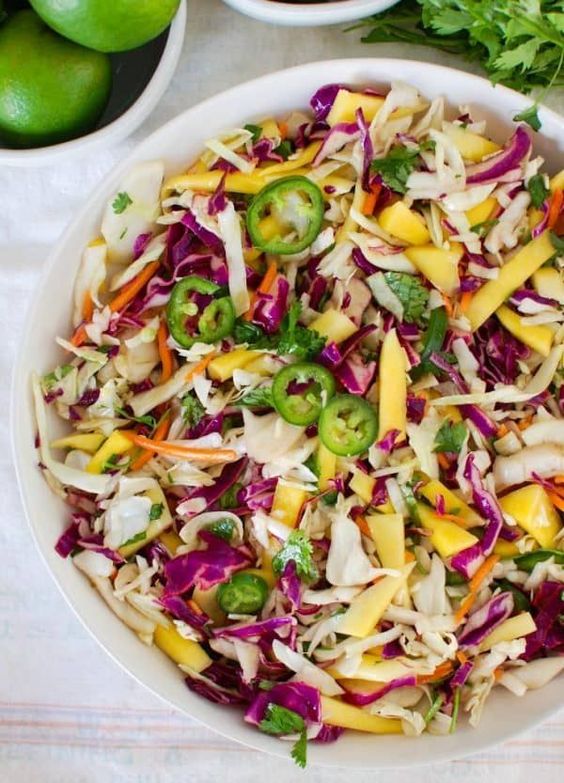 Overhead view of mango cabbage coleslaw in a serving bowl.