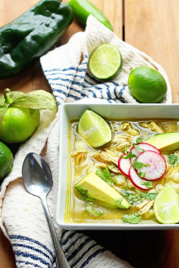 Overhead view of a bowl of Mexican Chicken Pozole with limes.