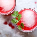 Rhubarb margaritas in glasses garnished with cilantro