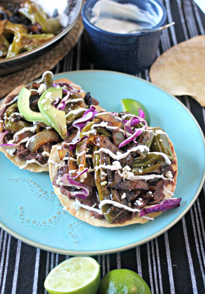 Two shishito tostadas on a blue plate.
