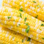 Air fryer corn on the cob with parsley and butter