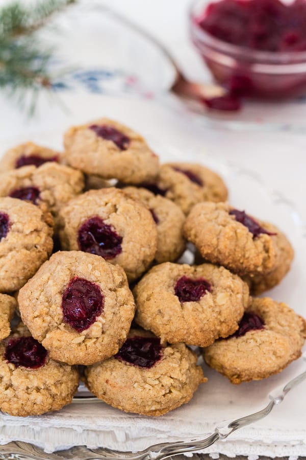 A plate piled high with almond thumbprint cookies.