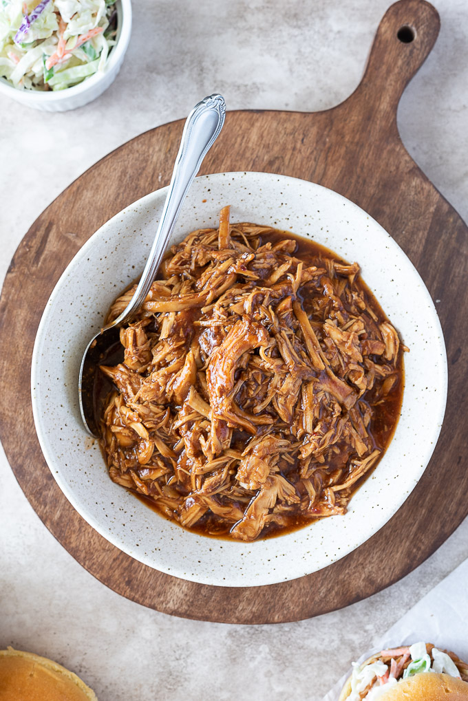 Bowl of bbq pulled chicken with a spoon