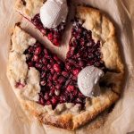 Overhead view of a cranberry galette with one slice slid out.