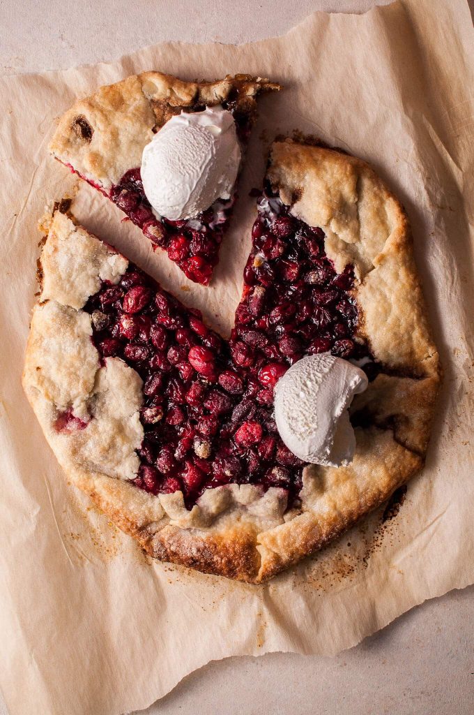 Overhead view of a cranberry galette with one slice slid out.