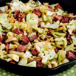 Fried cabbage and corned beef in cast iron skillet.