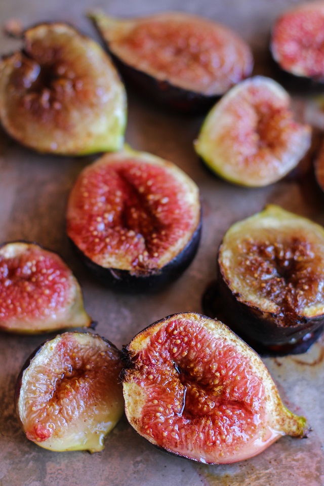 Maple roasted figs scattered on a baking tray.