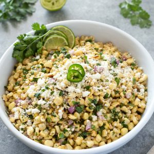 Mexican corn salad in a bowl with jalapeno on top