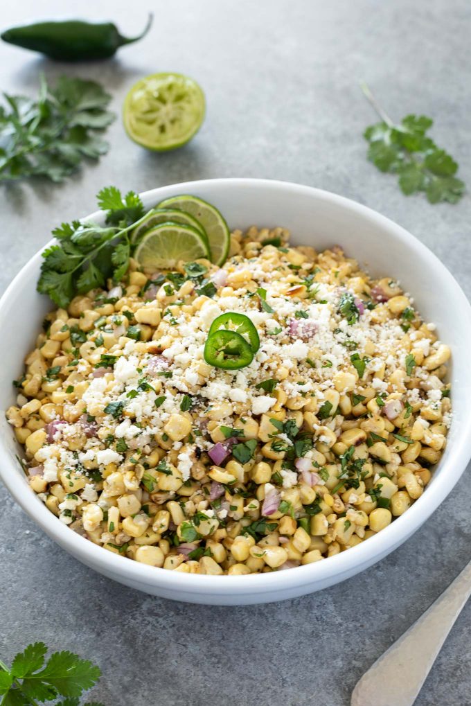 Mexican corn salad in a bowl with jalapeno on top