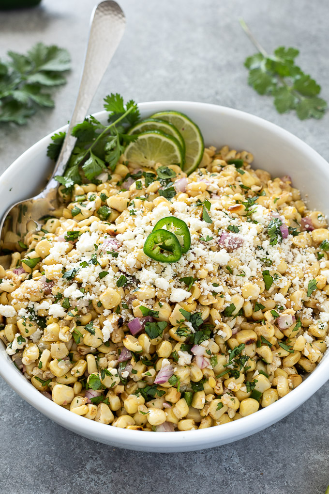 Mexican corn salad topped with jalapeno, lime and cilantro