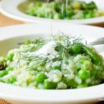Two white bowls of spring risotto.