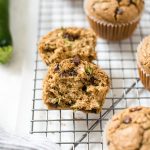 Oat flour zucchini chocolate chips muffins on a wire rack.