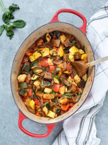 Ratatouille in a Dutch oven with basil on top
