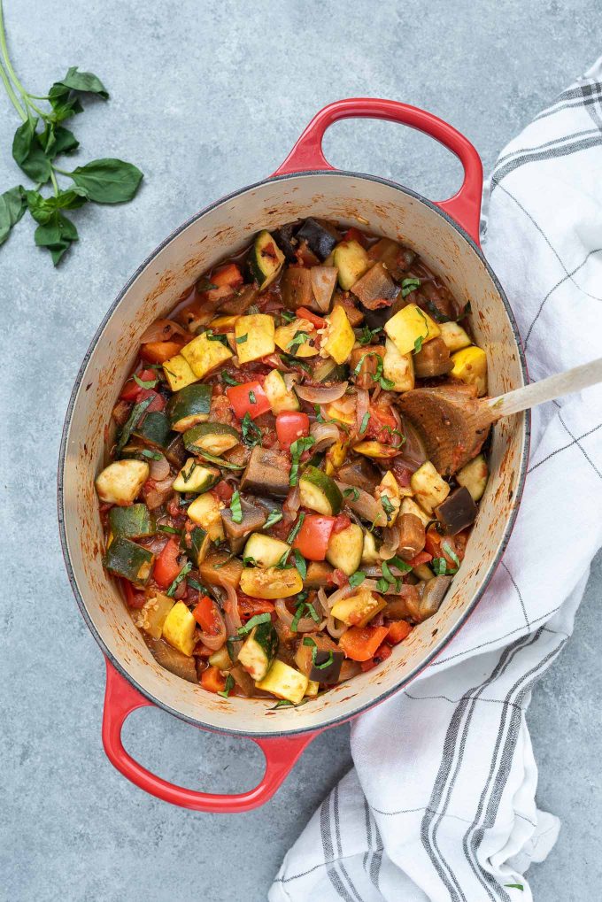 Ratatouille in a Dutch oven with basil on top