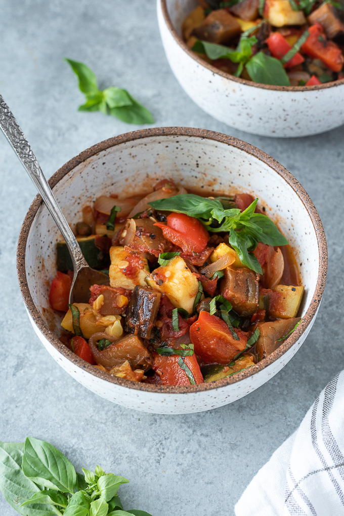 Bowl of ratatouille with fresh basil on top