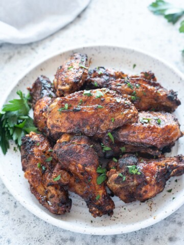Air fryer chicken wings piled on a plate