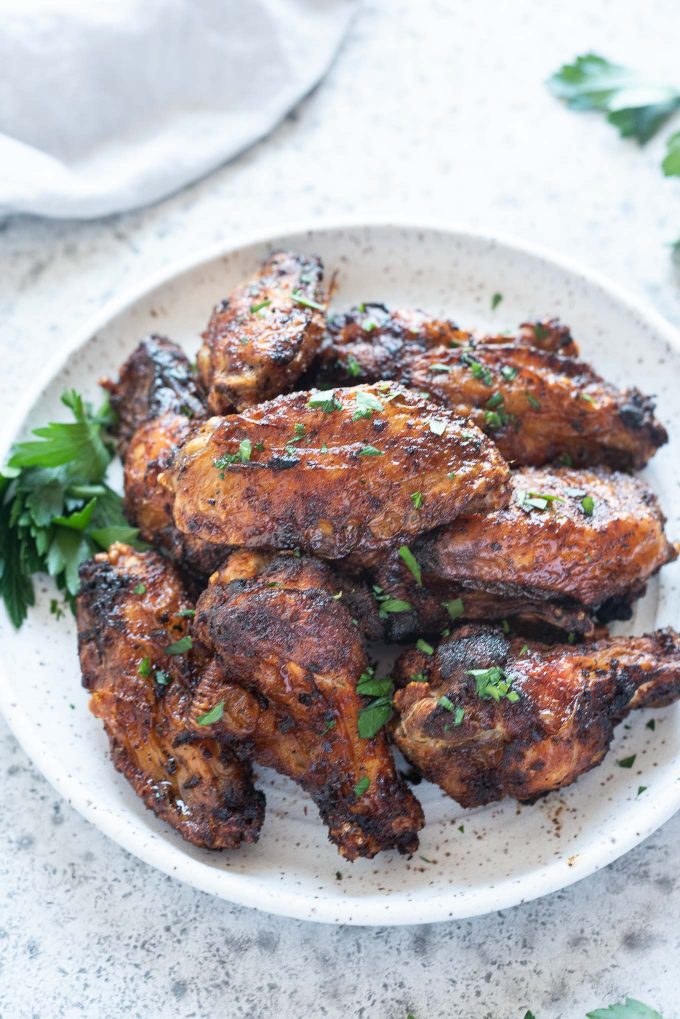 Air fryer chicken wings piled on a plate