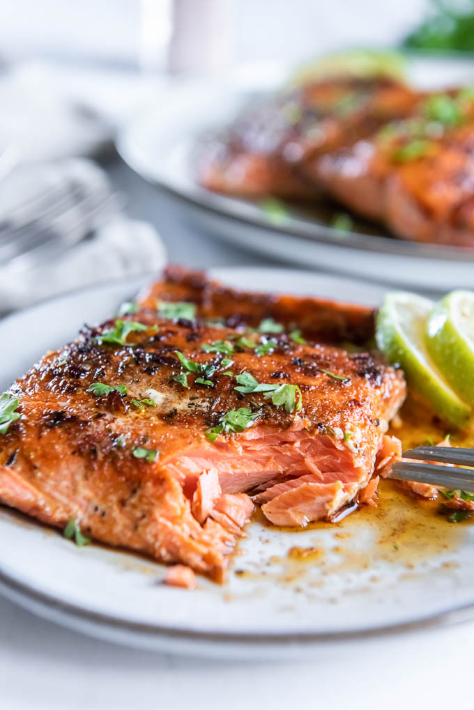 Blackened salmon on a plate with a bite taken out