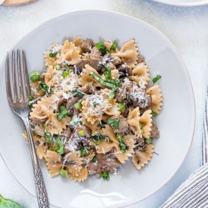 Italian sausage pasta on a plate with a fork