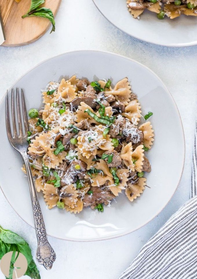 Italian sausage pasta on a plate with a fork