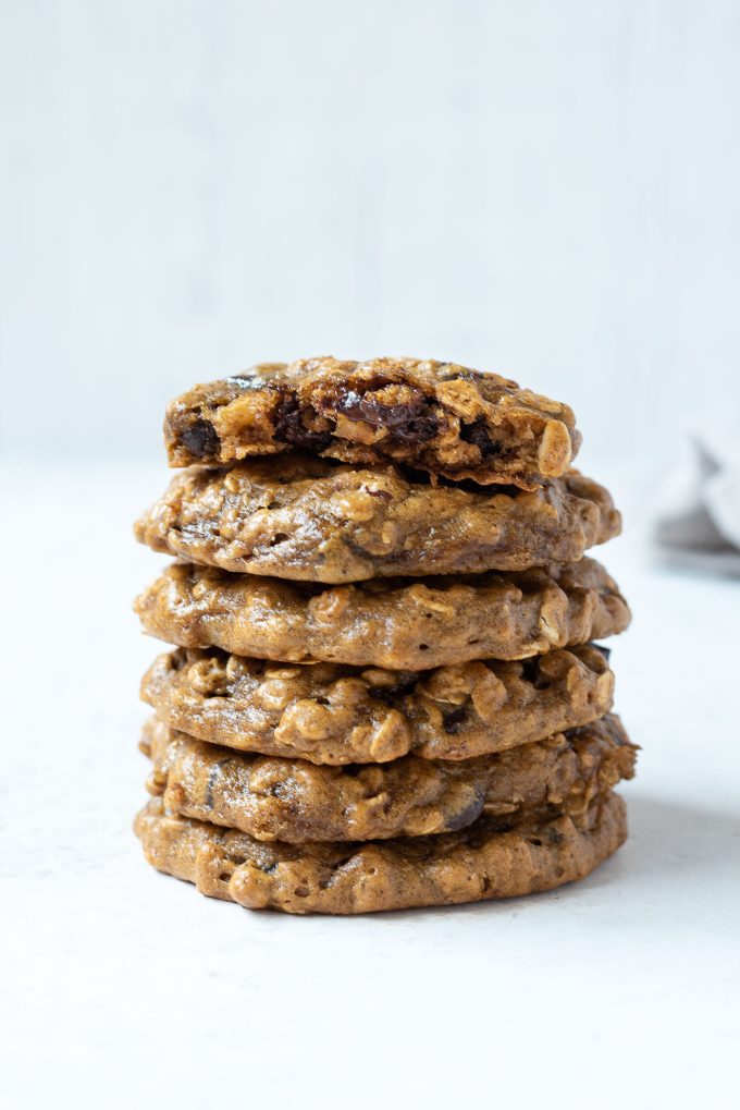 Stack of peanut butter banana oatmeal cookies with top cookie in half