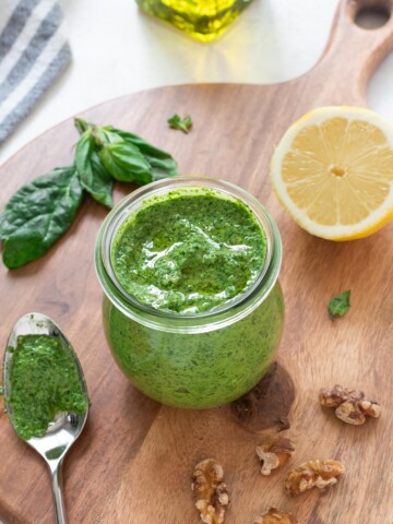 Spinach pesto in a jar with olive oil on top