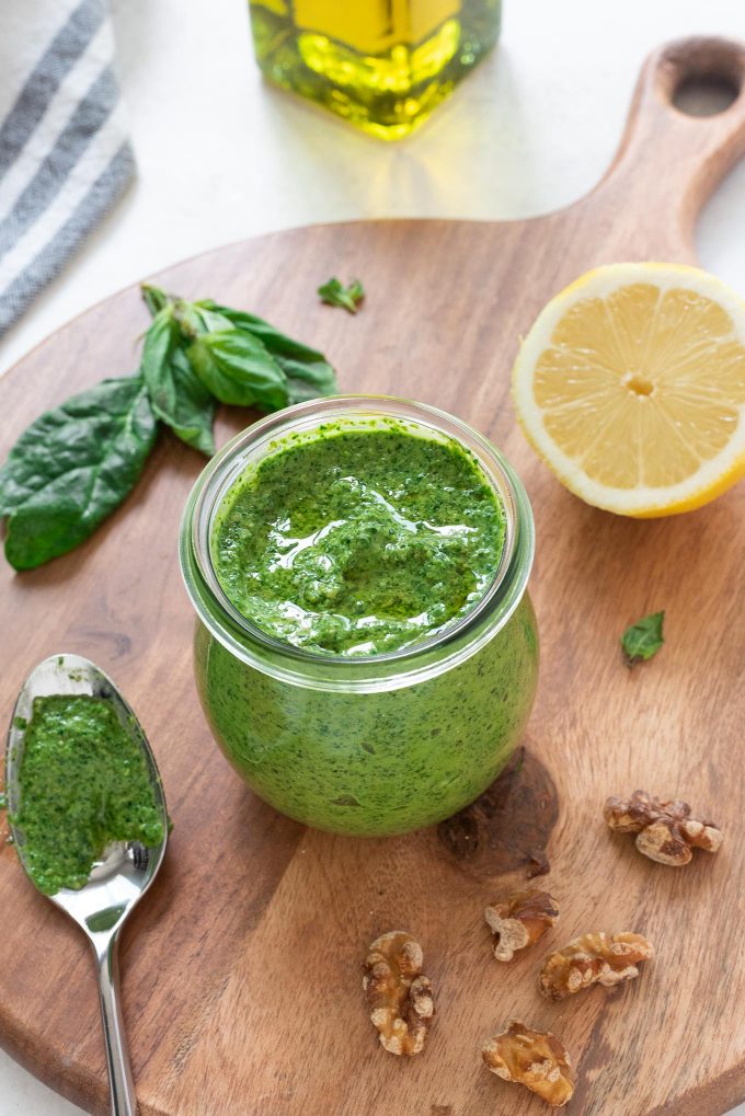 Spinach pesto in a jar with olive oil on top
